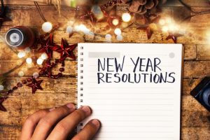 notebook-saying-new-year-resolutions-open-on-festive-background